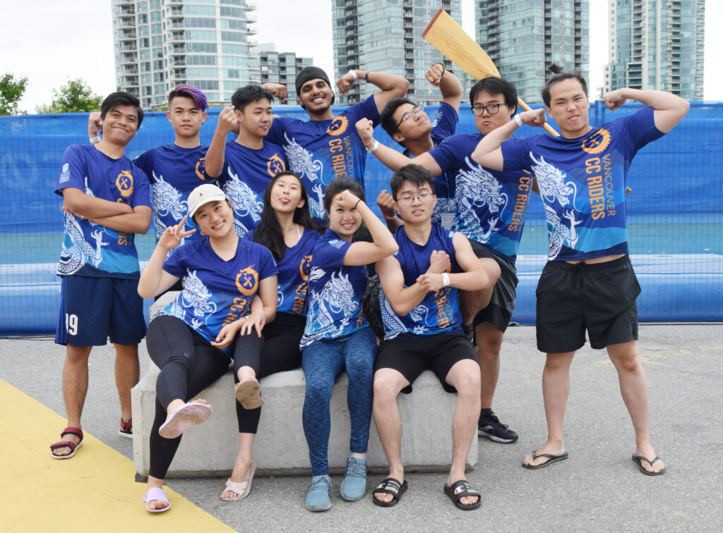 Students in dragon boat team jerseys posing for a group photo